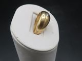 a small white box with a gold leaf on it