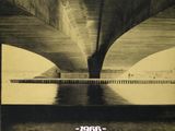 an image of a black and white photo of a bridge over water