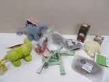 several stuffed animals are sitting on a table next to other items