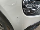a close up of a car ' s front bumper and headlight