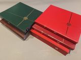 two red and green boxes are stacked on top of each other