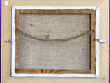 a close up of a picture frame with a rope hanging from it