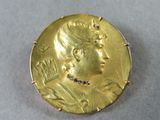 an image of a gold coin with a woman ' s face on it