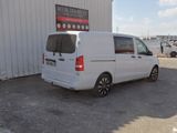 a white van that is parked in front of a building