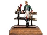 une figurine représentant un homme assis sur un banc avec un chien