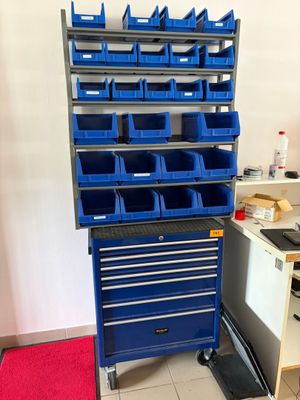 une armoire à outils bleue surmontée de nombreux bacs