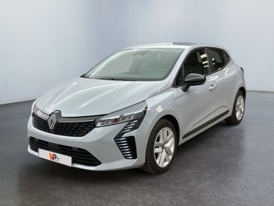 a silver car parked in a white room with a black floor