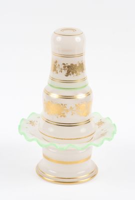 a white vase with a gold and green decoration on it
