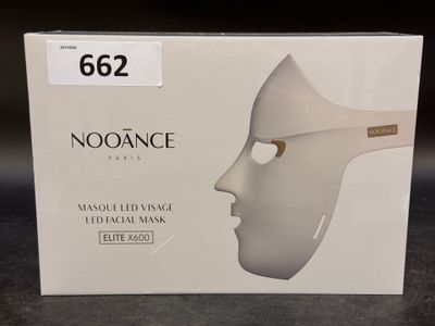 a box with a white mask on it on a table