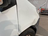 a close up of a white truck parked in a parking lot