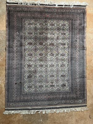 an old rug hanging on a wall in a room
