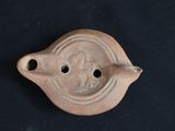 a close up of a clay object on a black surface