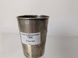 a silver cup with a sticker on it sitting on a table