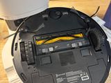 a robot that is sitting on a table next to a laptop