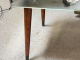 a glass table with a mirror on top of it