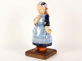 a figurine of a woman with a cat on her shoulder