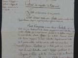 an old document with writing on it sitting on top of a table