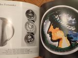 a book with a picture of a woman ' s face and a picture of a vase