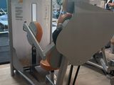 a man that is sitting on a machine in the gym
