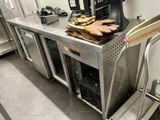 stainless steel counter with oven and ovening equipment in a commercial kitchen