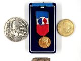 a medal and a coin sitting next to each other on a table