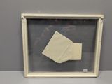 an origami paper origami in a glass frame on a table