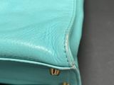 the inside of a blue purse with a zipper on it