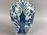 a blue and white vase sitting on a table