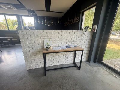 a table with a book on it in front of a window