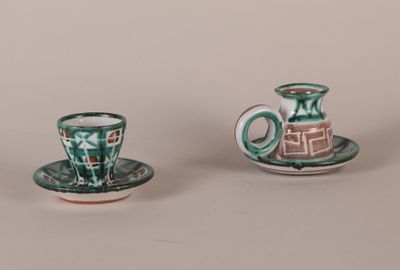 three small cups and saucers sitting on a table