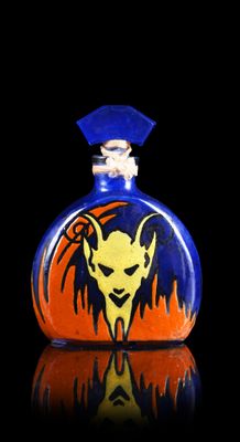 a small glass bottle with a picture of a devil on it