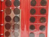 a red book with a lot of coins inside of it