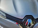 a close up of the front of a car with a badge on it