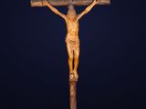 a wooden crucifix with a cross on a black background