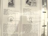 two pages of paper with stamps on them on a table