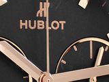 close up of a watch with a black face and gold hands