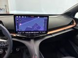 the interior of a car with a touch screen and a steering wheel