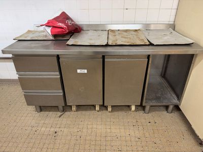 un plan de travail en métal sur lequel sont posées plusieurs casseroles