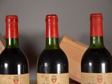 three bottles of wine sitting on top of a table next to a wooden box