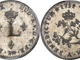 a silver coin with a crown on the front and a crown on the back