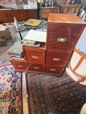 a dresser and a chair in a room with a rug