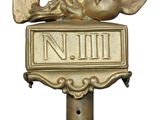 a statue of a horse on top of a street sign