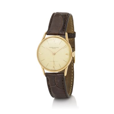 a gold plated wrist watch with brown leather strap