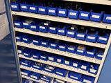 many bins of blue and white containers on the shelf