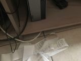 a pile of papers on the floor next to a computer