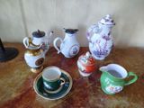 many different types of teapots and cups on the table