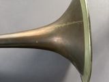 an old brass trumpet sitting on top of a table next to a pair of scissors
