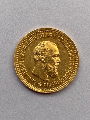 l'image d'une pièce d'or sur laquelle figure le visage d'un homme