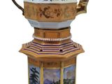 a teapot with a picture of a pagoda on it