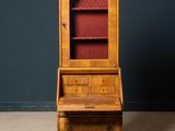 an old wooden desk with a book shelf and a red chair